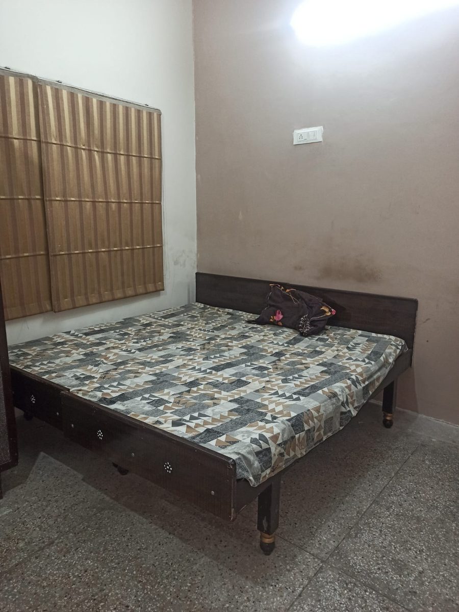 Double bed with mattress and window blinds