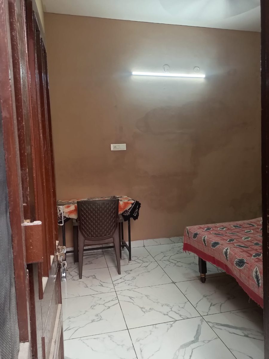 Full room view — bed, study table and chair